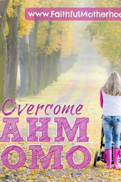 Woman pushing stroller down a lonely road flanked by trees.