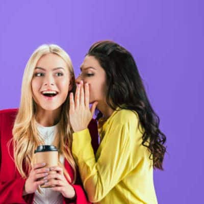 Two women gossiping, purple background