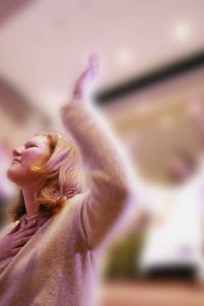 Woman with hands lifted in worship